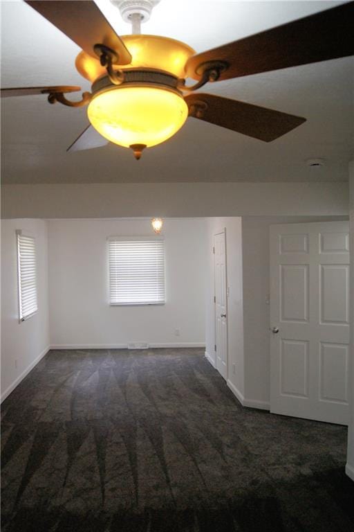 1919 Seneca St, Leavenworth, KS 66048 - spare room featuring carpet, baseboards, and a ceiling fan