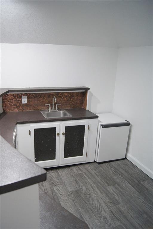 1919 Seneca St, Leavenworth, KS 66048 - bar with a sink, baseboards, and fridge