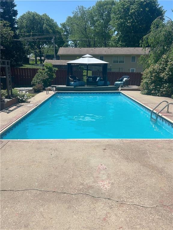 1919 Seneca St, Leavenworth, KS 66048 - view of swimming pool with a gazebo, a fenced backyard, a patio area, and view of wooded area