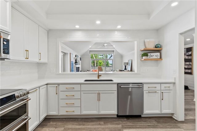 5037 W 120th Ter, Overland Park, KS 66209 - kitchen featuring stainless steel appliances, wood finished floors, ceiling fan, recessed lighting, and white cabinetry