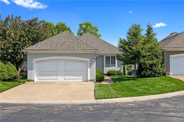 5037 W 120th Ter, Overland Park, KS 66209 - view of front of house featuring stucco siding, a front yard, driveway, roof with shingles, and a garage
