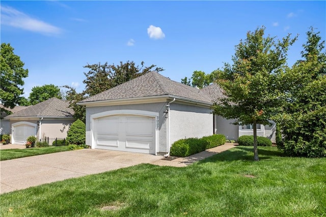 5037 W 120th Ter, Overland Park, KS 66209 - view of home's exterior with concrete driveway, a lawn, stucco siding, an attached garage, and roof with shingles