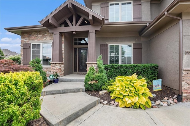 25205 W 97th Ter, Lenexa, KS 66227 - doorway to property with stucco siding and stone siding