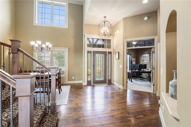 25205 W 97th Ter, Lenexa, KS 66227 - entryway featuring a chandelier, wood finished floors, and a towering ceiling