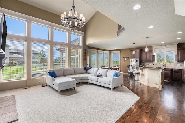 25205 W 97th Ter, Lenexa, KS 66227 - living area with a chandelier, plenty of natural light, dark wood-style flooring, recessed lighting, and a textured ceiling