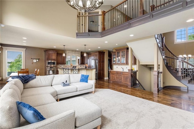 25205 W 97th Ter, Lenexa, KS 66227 - living area with a chandelier, dark wood finished floors, recessed lighting, plenty of natural light, and a high ceiling