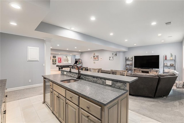 25205 W 97th Ter, Lenexa, KS 66227 - kitchen featuring dark countertops, open floor plan, light carpet, an island with sink, and recessed lighting