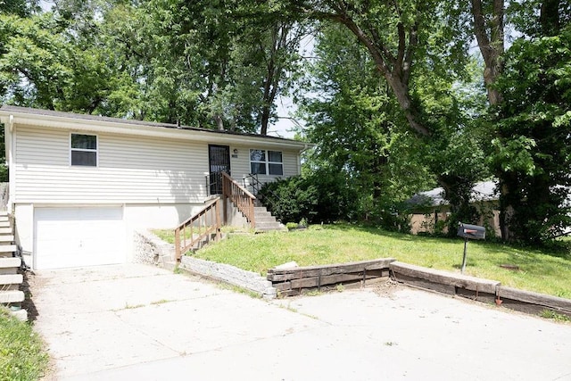 108 N Evanston Ave, Independence, MO 64053 - ranch-style house featuring stairs, a front yard, an attached garage, and concrete driveway