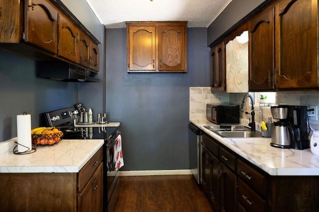 108 N Evanston Ave, Independence, MO 64053 - kitchen featuring stainless steel appliances, under cabinet range hood, dark wood finished floors, light countertops, and a sink