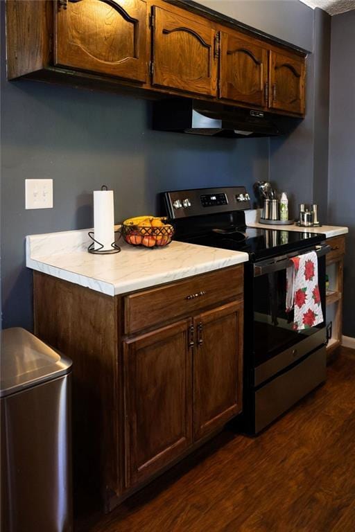 108 N Evanston Ave, Independence, MO 64053 - kitchen with stainless steel range with electric cooktop, light countertops, dark wood finished floors, and under cabinet range hood