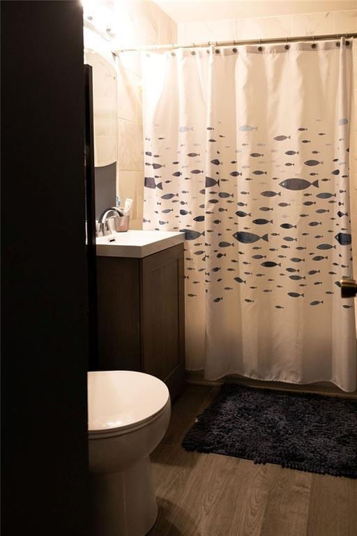 108 N Evanston Ave, Independence, MO 64053 - bathroom featuring wood finished floors, vanity, toilet, and curtained shower