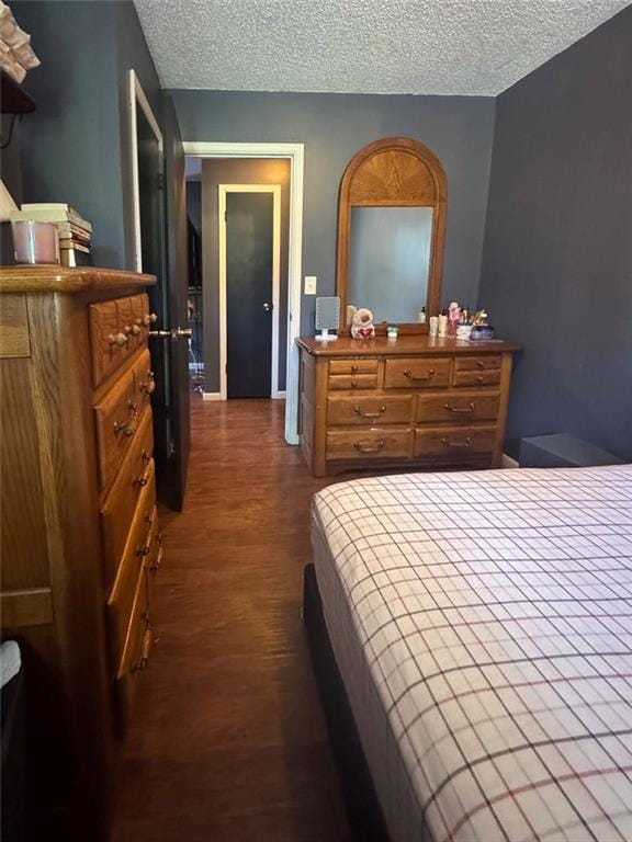 108 N Evanston Ave, Independence, MO 64053 - bedroom featuring dark wood-style floors and a textured ceiling