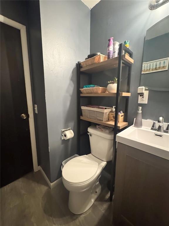 108 N Evanston Ave, Independence, MO 64053 - bathroom with toilet, vanity, and baseboards