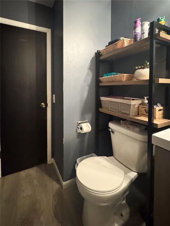 108 N Evanston Ave, Independence, MO 64053 - bathroom with toilet, wood finished floors, and baseboards