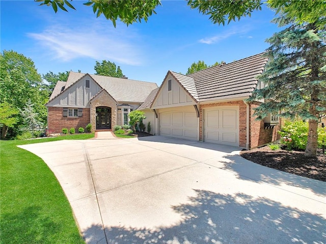 11349 Buena Vista St, Leawood, KS 66211 - tudor home featuring board and batten siding, a garage, driveway, a tile roof, and brick siding