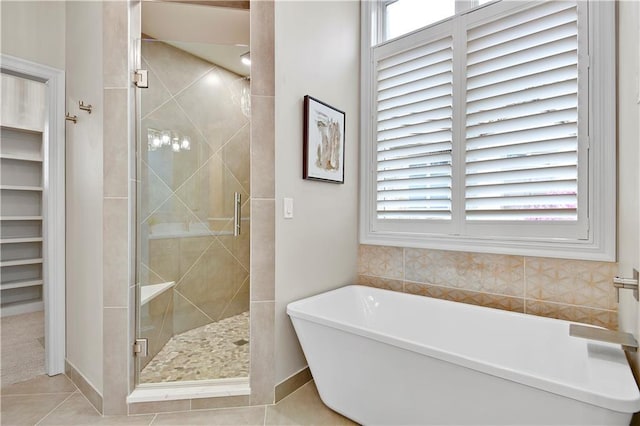 11349 Buena Vista St, Leawood, KS 66211 - full bath with a stall shower, a freestanding tub, and tile patterned floors