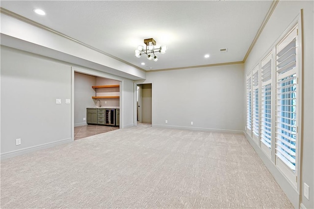 11349 Buena Vista St, Leawood, KS 66211 - unfurnished living room featuring crown molding, light colored carpet, recessed lighting, baseboards, and bar