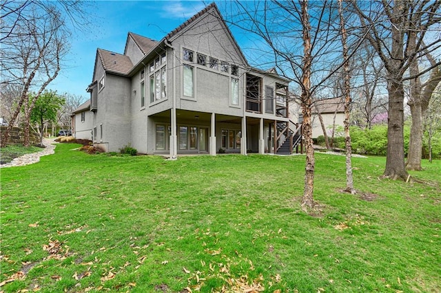 11349 Buena Vista St, Leawood, KS 66211 - back of property featuring stucco siding, a yard, and stairs