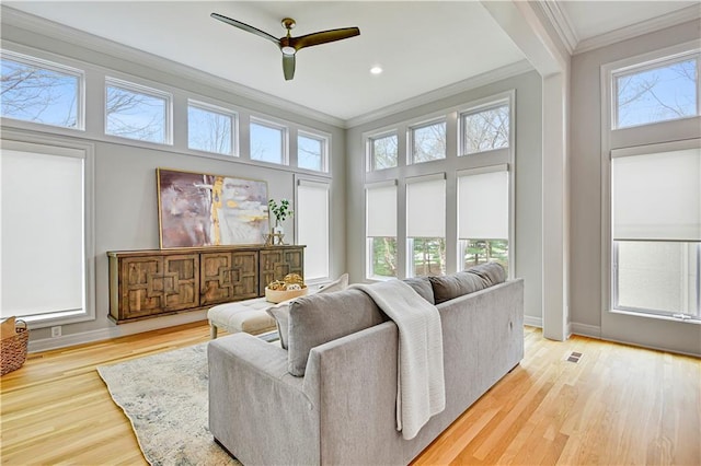 11349 Buena Vista St, Leawood, KS 66211 - living room featuring crown molding, healthy amount of natural light, wood finished floors, ceiling fan, and baseboards