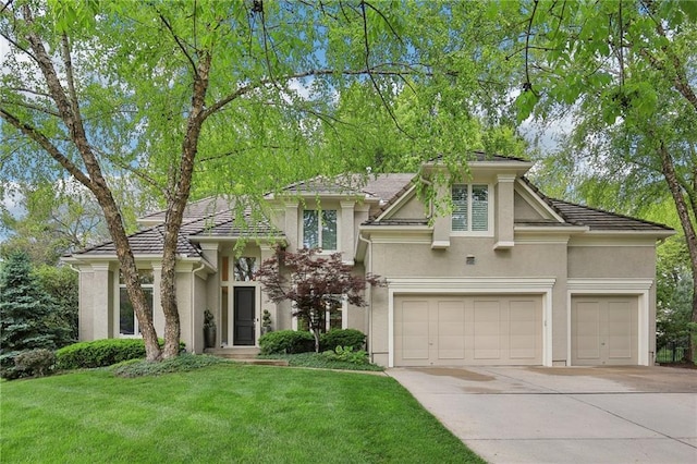 14814 Sherwood St, Leawood, KS 66224 - view of front of house with concrete driveway, stucco siding, a front lawn, a garage, and a tiled roof