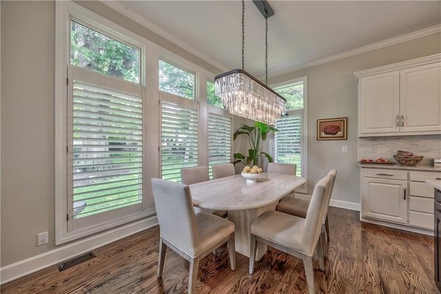 14814 Sherwood St, Leawood, KS 66224 - dining area with a chandelier, crown molding, dark wood-style flooring, and baseboards