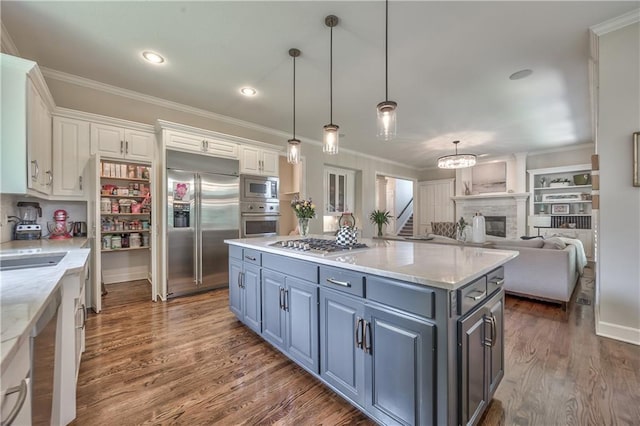 14814 Sherwood St, Leawood, KS 66224 - kitchen with built in appliances, white cabinetry, a center island, wood finished floors, and crown molding