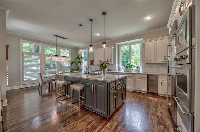 14814 Sherwood St, Leawood, KS 66224 - kitchen featuring white cabinetry, light countertops, crown molding, a kitchen bar, and dark wood-style floors
