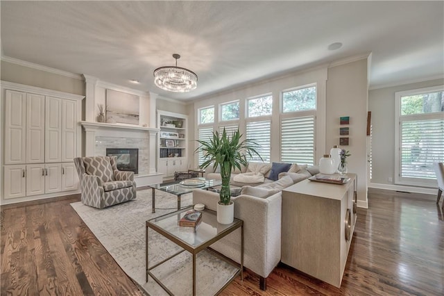 14814 Sherwood St, Leawood, KS 66224 - living room with crown molding, dark wood finished floors, healthy amount of natural light, and a chandelier