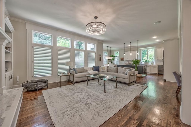 14814 Sherwood St, Leawood, KS 66224 - living area with ornamental molding, a chandelier, and dark wood-style flooring