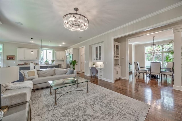 14814 Sherwood St, Leawood, KS 66224 - living room featuring a chandelier, dark wood-type flooring, ornamental molding, and baseboards