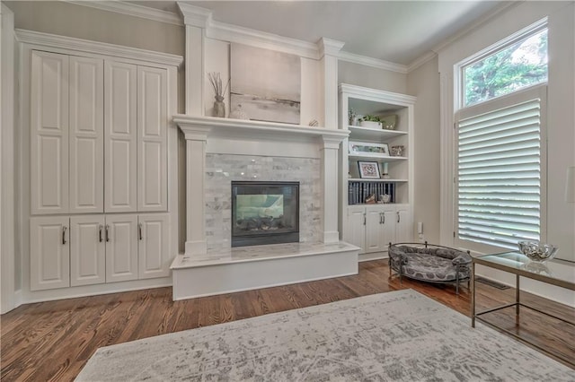 14814 Sherwood St, Leawood, KS 66224 - living room featuring wood finished floors, a glass covered fireplace, crown molding, and built in features
