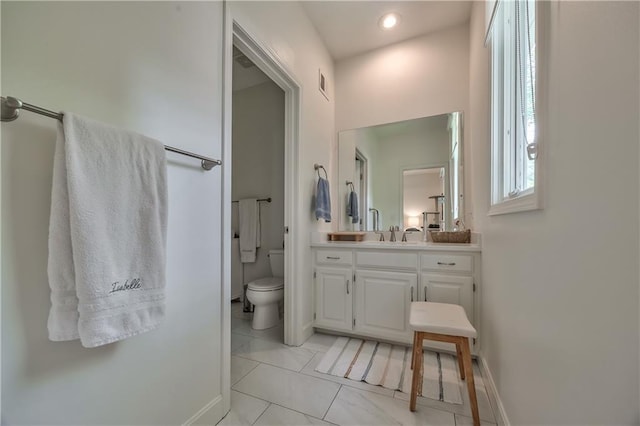 14814 Sherwood St, Leawood, KS 66224 - bathroom featuring toilet, vanity, baseboards, and recessed lighting