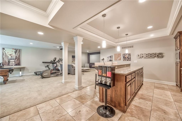 14814 Sherwood St, Leawood, KS 66224 - kitchen with open floor plan, ornate columns, a raised ceiling, light colored carpet, and light stone counters
