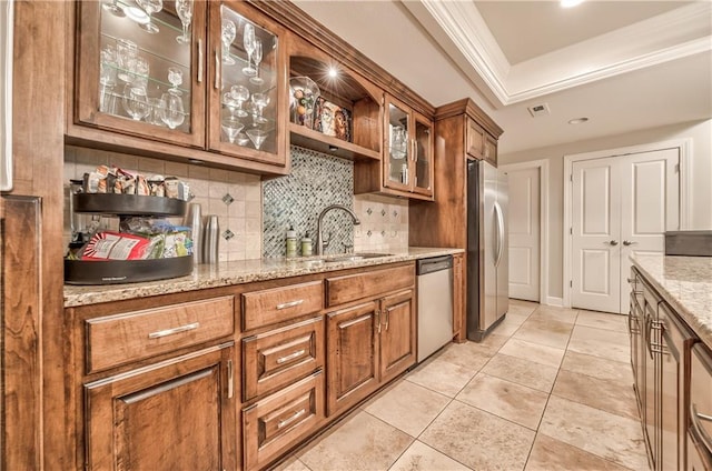 14814 Sherwood St, Leawood, KS 66224 - kitchen with stainless steel appliances, a sink, decorative backsplash, brown cabinets, and light stone counters