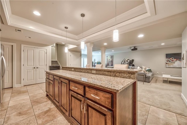 14814 Sherwood St, Leawood, KS 66224 - kitchen featuring a tray ceiling, brown cabinets, decorative columns, light stone counters, and recessed lighting