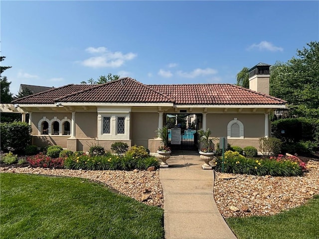 14814 Sherwood St, Leawood, KS 66224 - mediterranean / spanish house featuring a chimney, stucco siding, a tile roof, and a front lawn