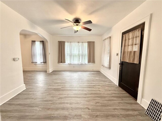 803 N Mulberry St, Maryville, MO 64468 - foyer entrance with a ceiling fan, wood finished floors, baseboards, and arched walkways