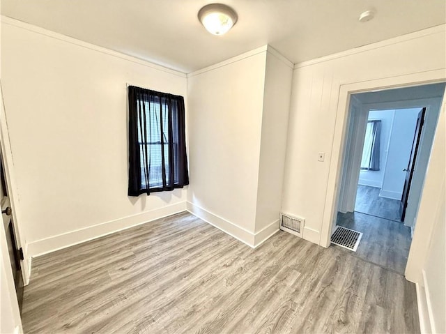 803 N Mulberry St, Maryville, MO 64468 - unfurnished room featuring wood finished floors, baseboards, ornamental molding, and a smoke detector