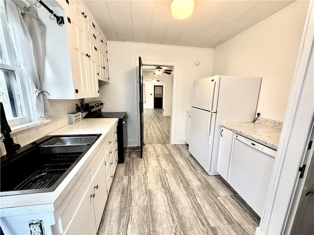 803 N Mulberry St, Maryville, MO 64468 - kitchen featuring white appliances, light wood-style floors, decorative backsplash, white cabinets, and a ceiling fan
