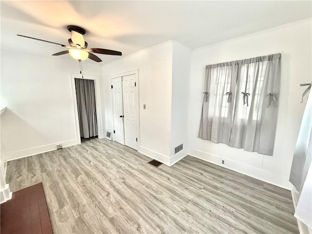 803 N Mulberry St, Maryville, MO 64468 - spare room with a ceiling fan, wood finished floors, baseboards, and ornamental molding