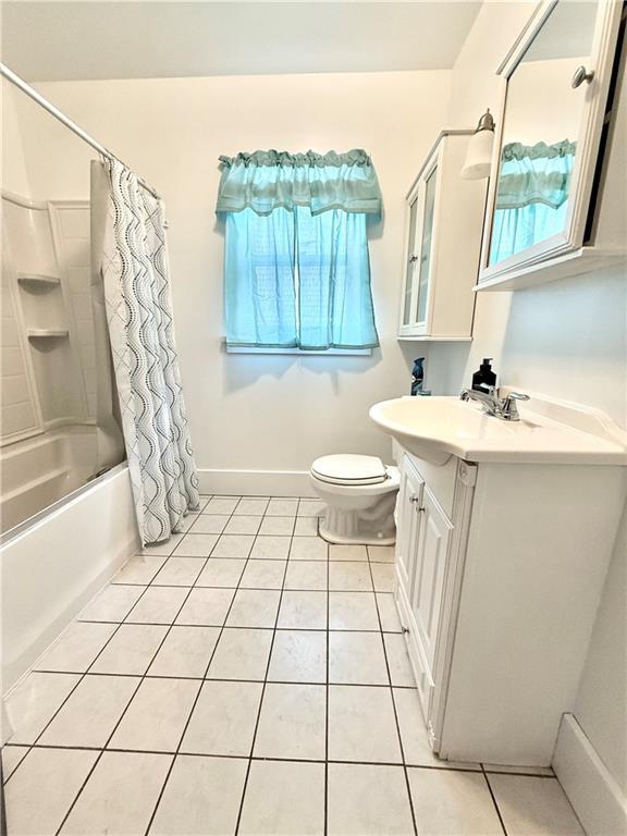 803 N Mulberry St, Maryville, MO 64468 - full bathroom featuring vanity, tile patterned floors, healthy amount of natural light, and toilet