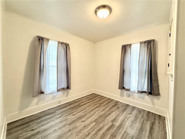 803 N Mulberry St, Maryville, MO 64468 - spare room featuring crown molding, wood finished floors, and baseboards