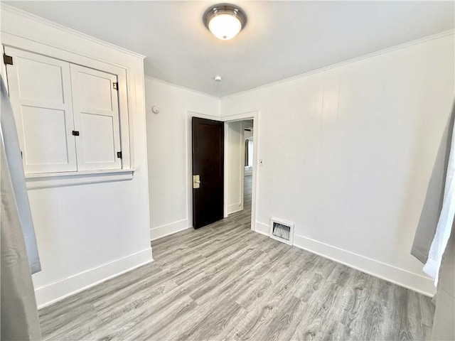 803 N Mulberry St, Maryville, MO 64468 - spare room with light wood-type flooring, crown molding, and baseboards