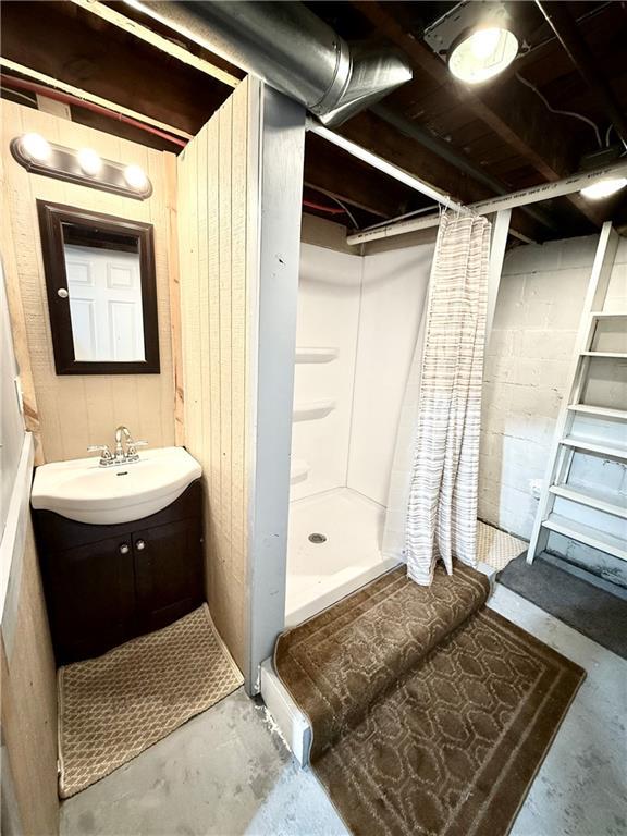 803 N Mulberry St, Maryville, MO 64468 - full bath with concrete flooring, vanity, and a shower stall