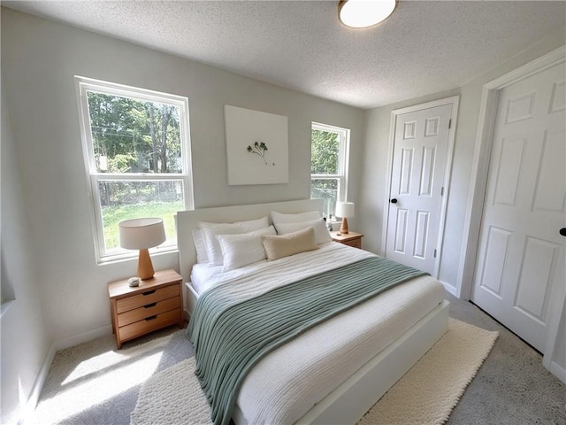 5715 Forest Ave, Kansas City, MO 64110 - bedroom featuring light colored carpet and a textured ceiling