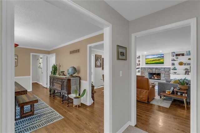 4212 NW Briarcliff Ln, Kansas City, MO 64116 - corridor featuring ornamental molding, wood finished floors, and baseboards