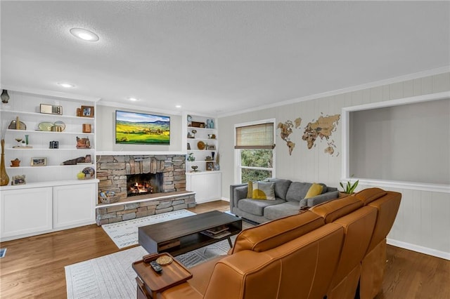 4212 NW Briarcliff Ln, Kansas City, MO 64116 - living area with wood finished floors, a fireplace, crown molding, built in shelves, and a textured ceiling