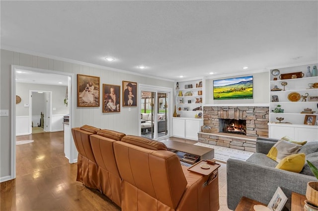 4212 NW Briarcliff Ln, Kansas City, MO 64116 - living area featuring crown molding, a fireplace, wood finished floors, recessed lighting, and a decorative wall