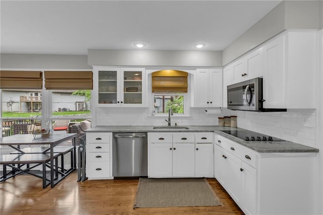 4212 NW Briarcliff Ln, Kansas City, MO 64116 - kitchen featuring stainless steel appliances, a sink, backsplash, white cabinetry, and recessed lighting