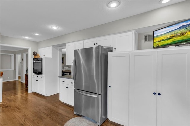 4212 NW Briarcliff Ln, Kansas City, MO 64116 - kitchen with freestanding refrigerator, oven, dark wood-type flooring, white cabinets, and recessed lighting